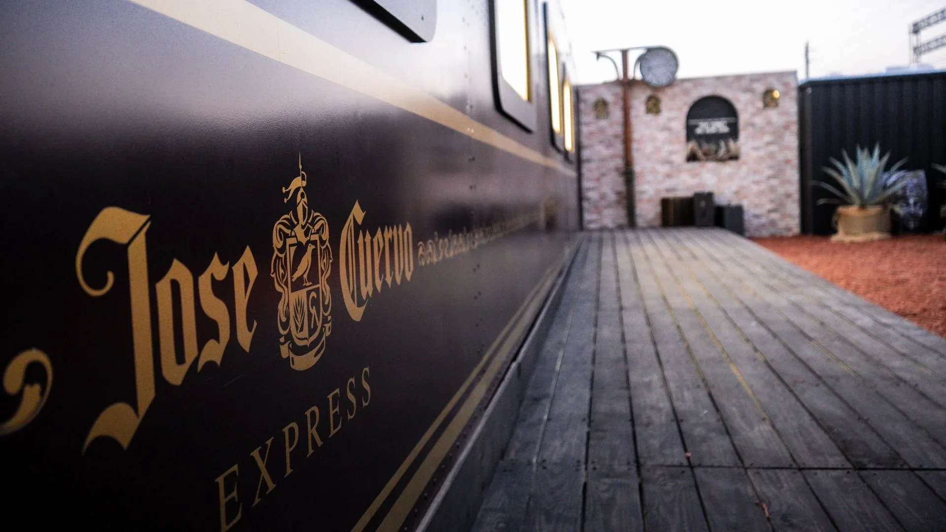A themed train room — passengers boarding a symbolic train ride through agave fields.